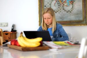 teen girl working on a computer